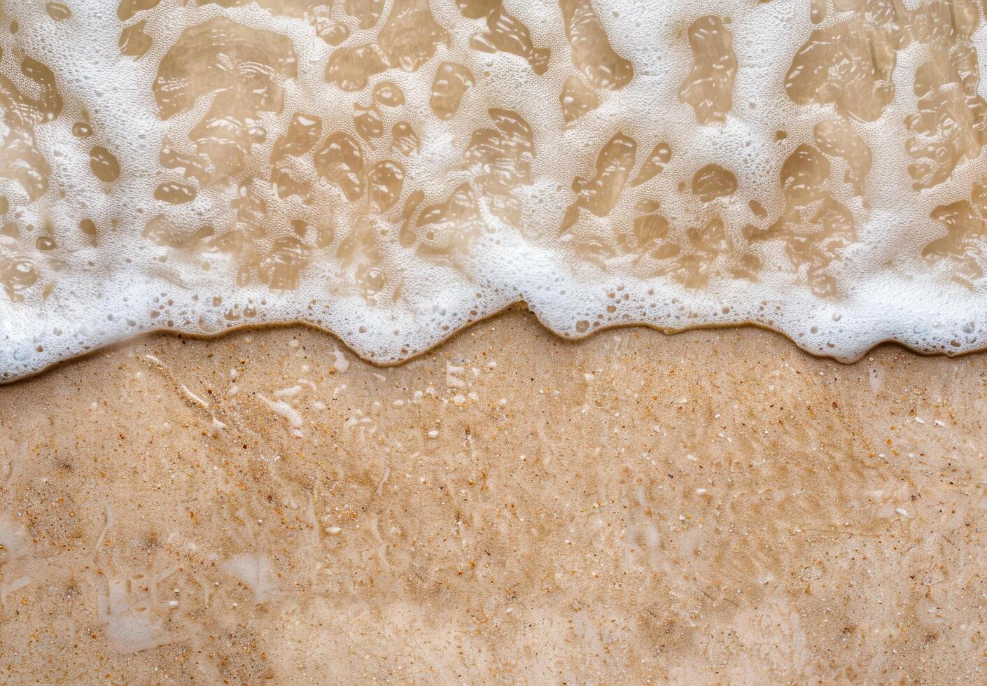 Foaming waves on sandy beach photo