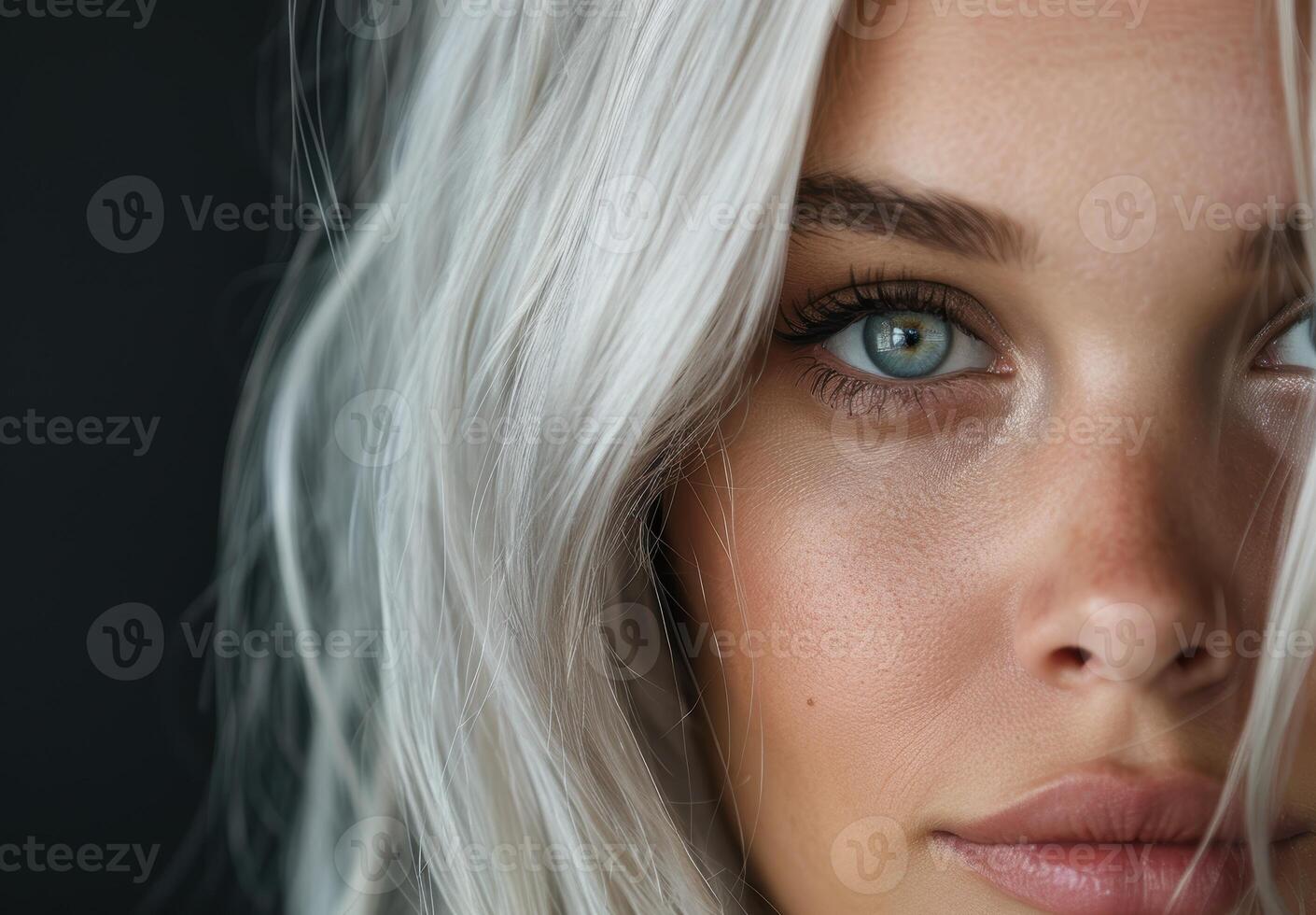 close up of a womans face with blonde hair and blue eyes photo