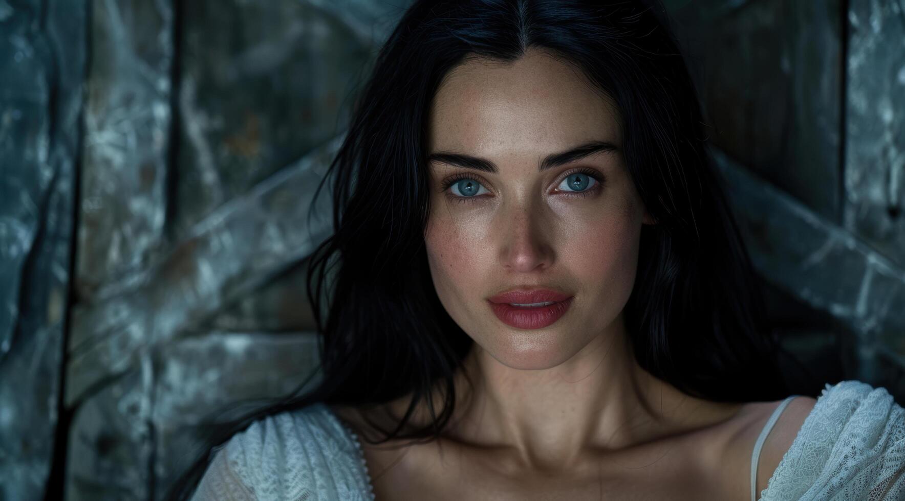 Mysterious woman with dark hair and piercing blue eyes photo