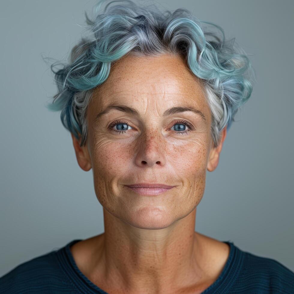 Mature woman with vibrant blue and gray curly hair photo