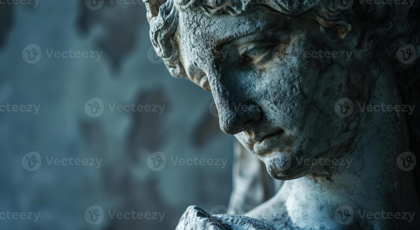 Weathered stone statue with pensive expression photo