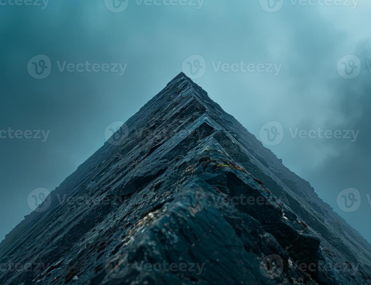 Dramatic rocky mountain peak in moody weather photo