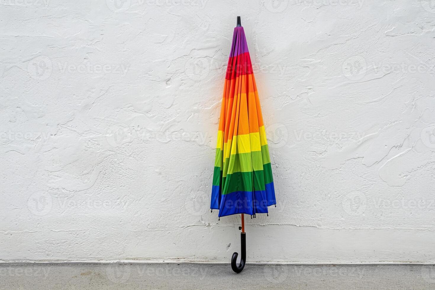 Colorful umbrella against a white wall photo