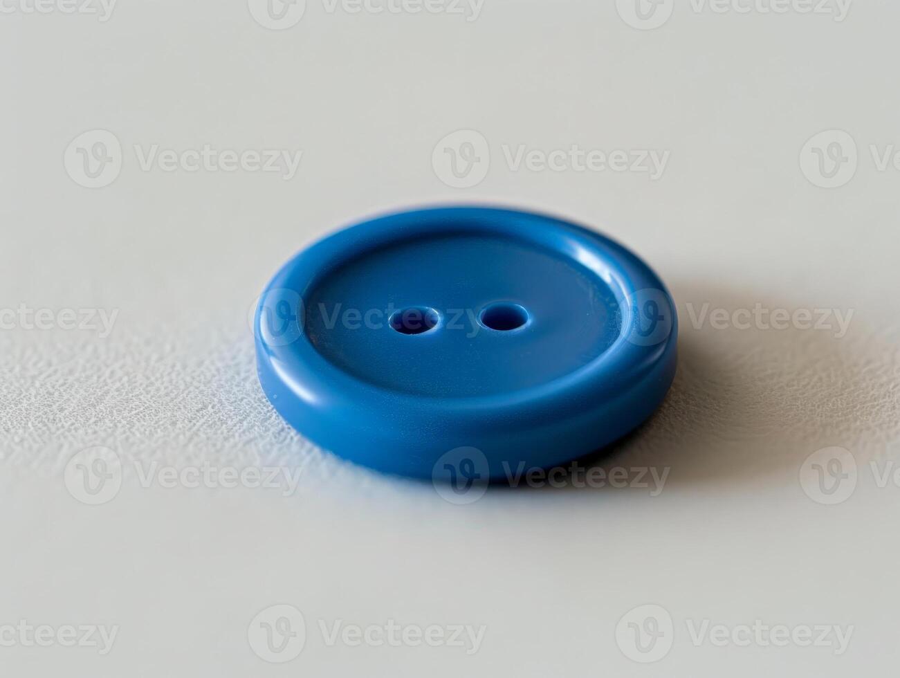 blue button on a textured surface photo
