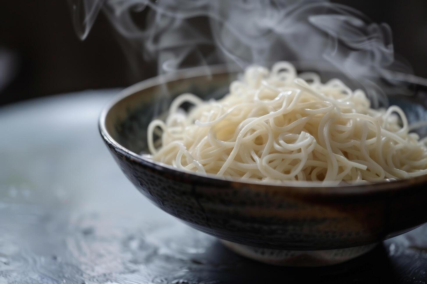 Steaming bowl of noodles photo