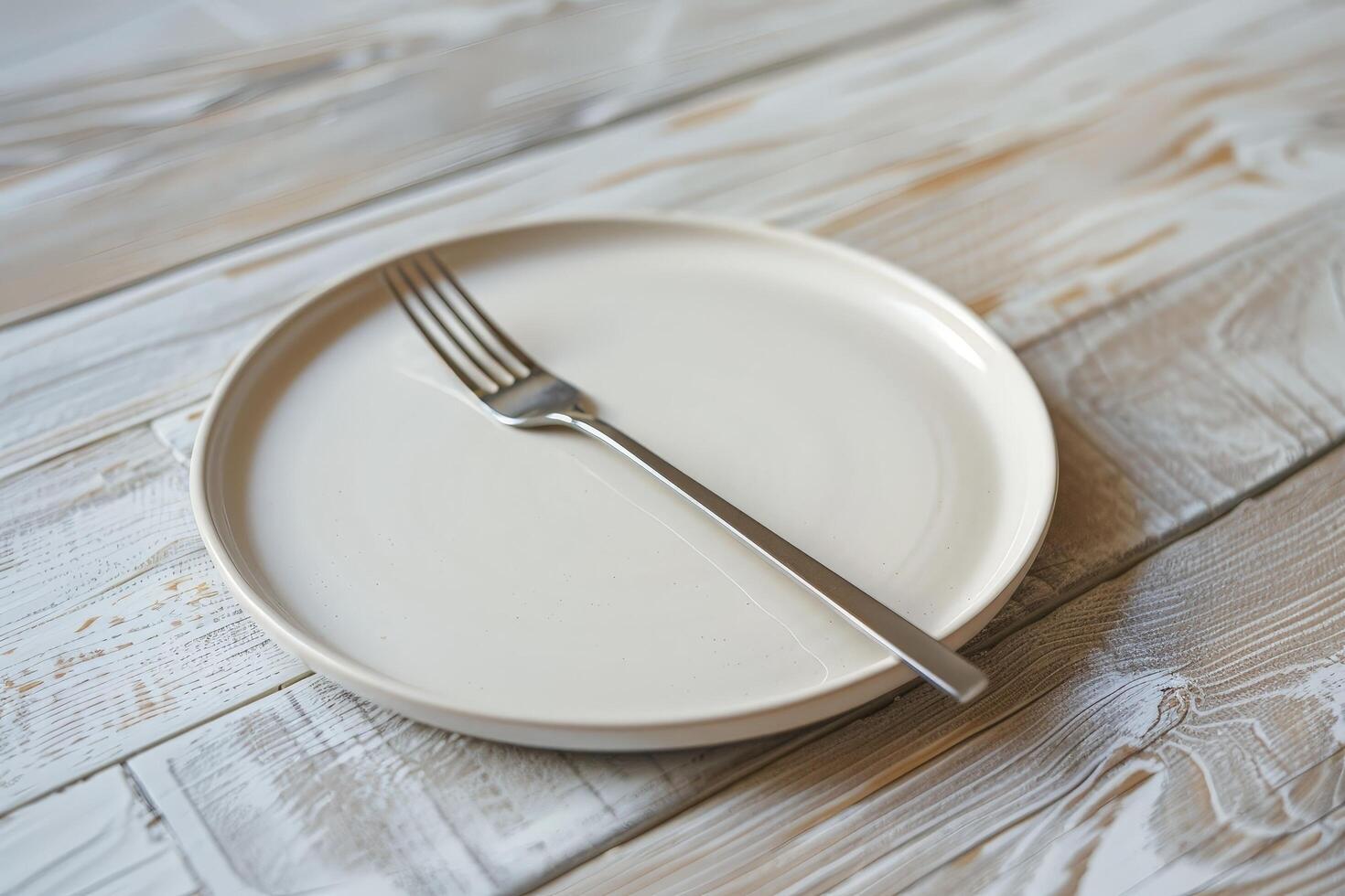 empty plate and fork on wooden table photo