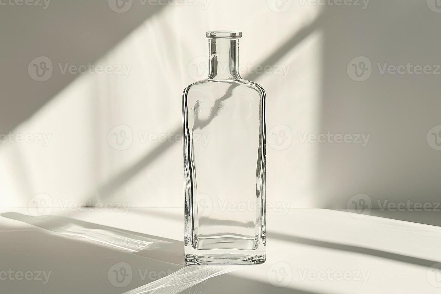 clear glass bottle on white surface photo
