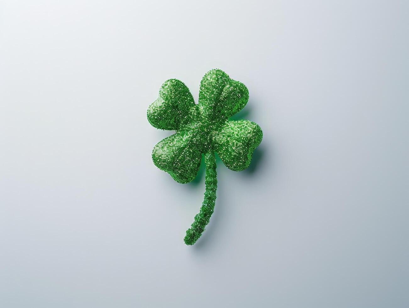 Glittering four leaf clover on a light background photo