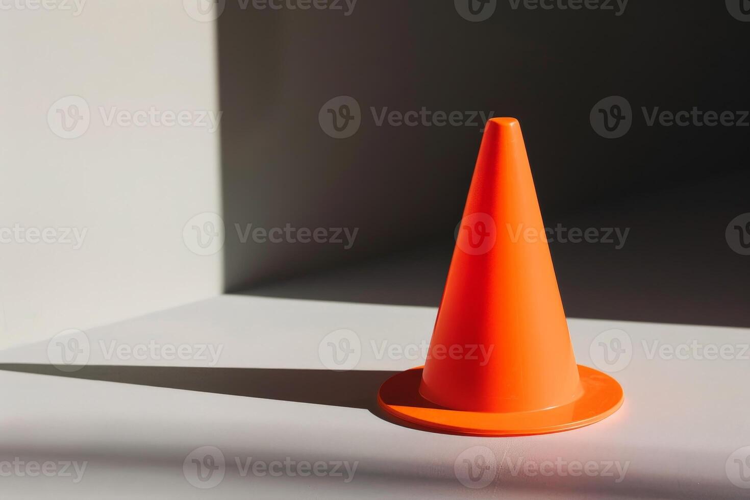 bright orange traffic cone on a minimalist background photo