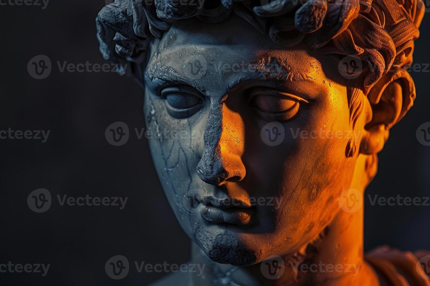 Close up of an ancient stone statue with dramatic lighting photo