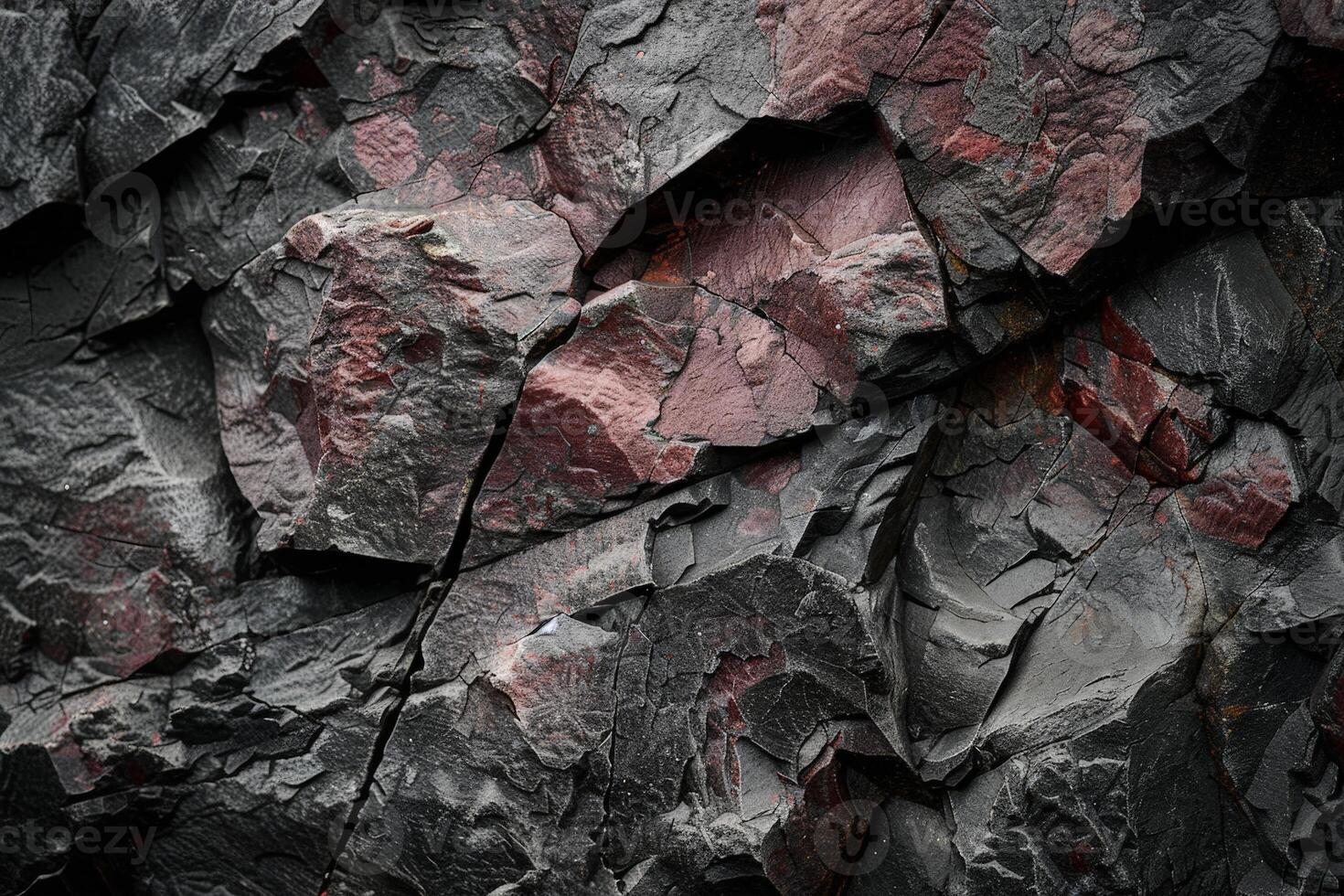 Textured rock surface with cracks and crevices photo