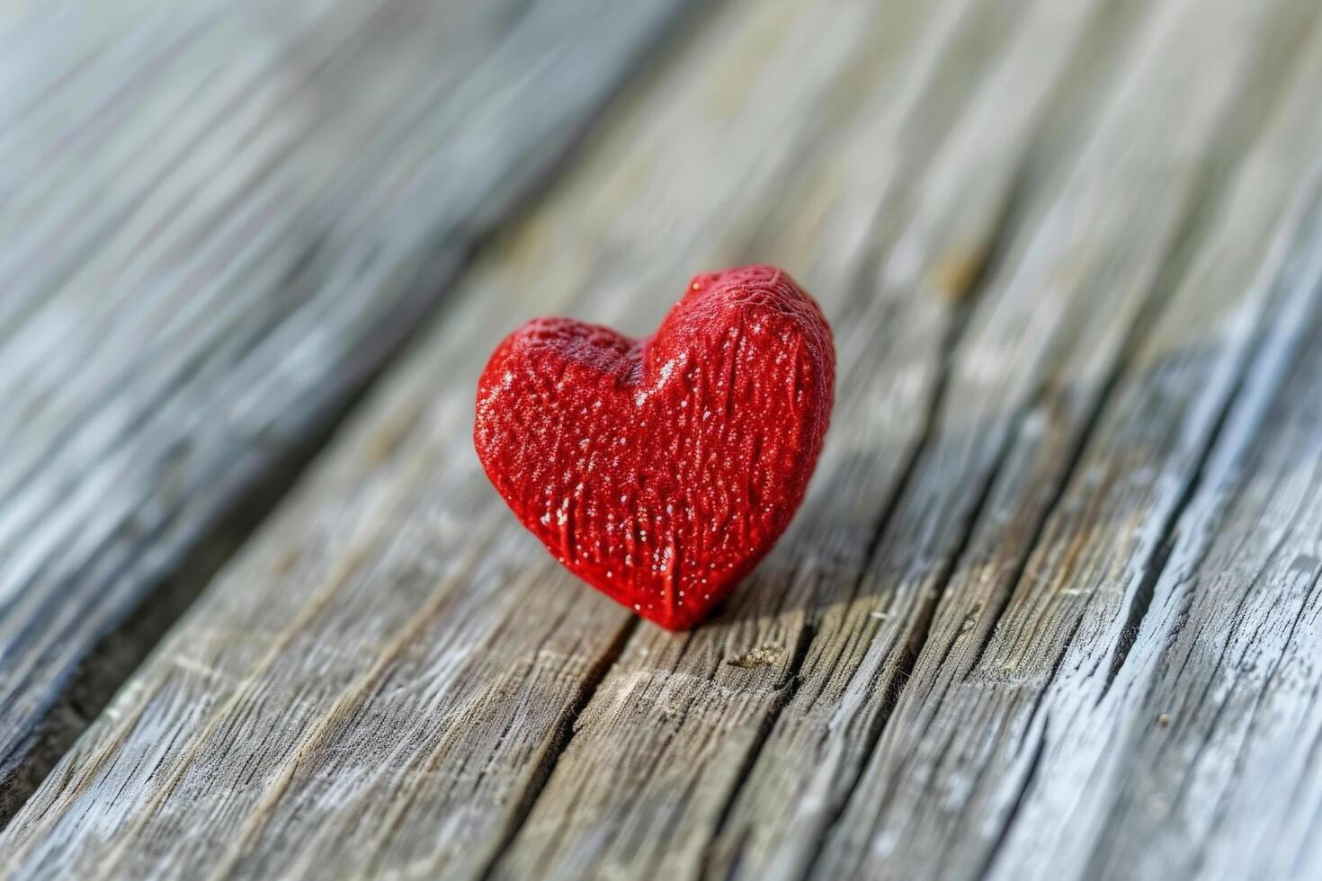 Vibrant red heart on weathered wooden surface photo