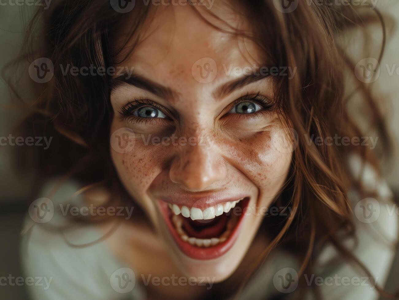 Joyful woman with freckles laughing photo
