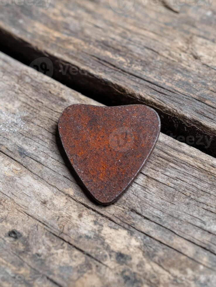 Rusty heart shaped object on weathered wood photo