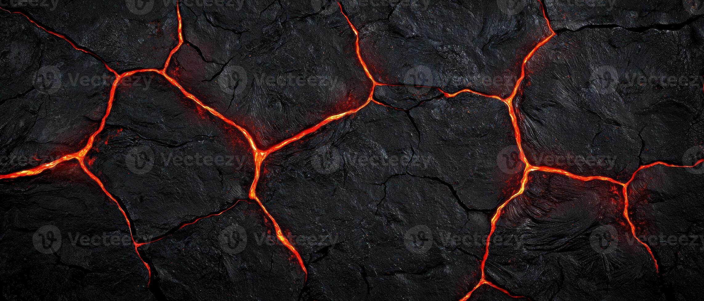 Glowing molten lava cracks in dark volcanic rock photo