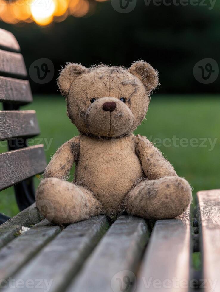 Vintage teddy bear sitting on a wooden bench photo