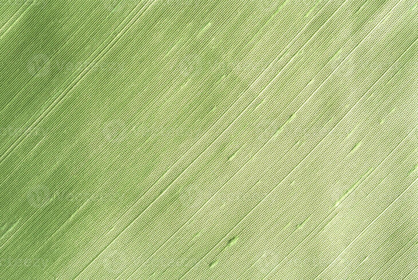 Green Fabric Close-Up with Fine Weave and Diagonal Stripes photo