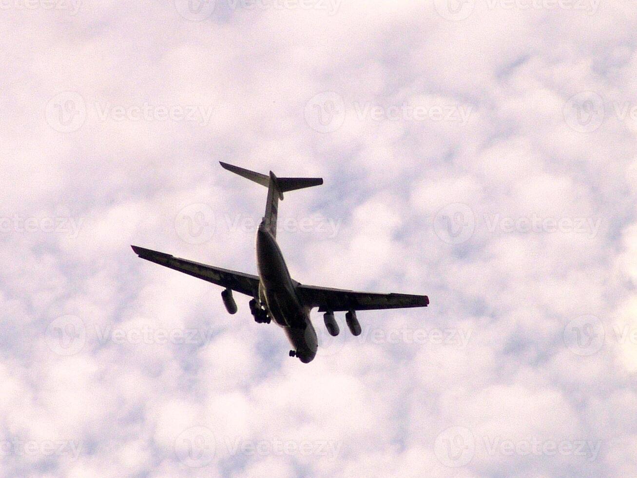 Commercial Aircraft in Flight Against a Cloudy Sky photo