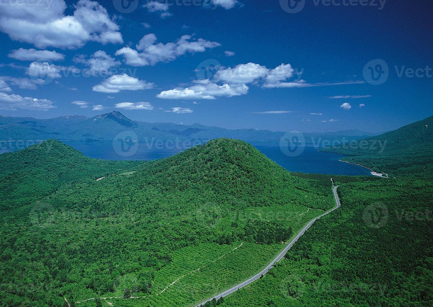 Breathtaking Highland Landscape with Cumulus Clouds and Serene Waters photo