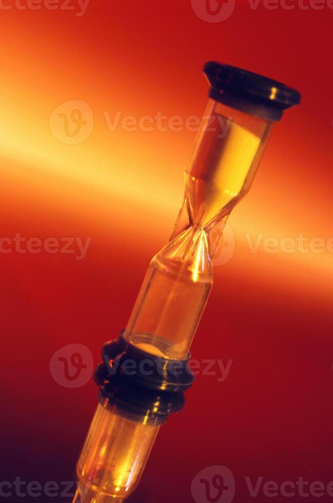 Hourglass Against Fiery Background Representing Time Passage photo