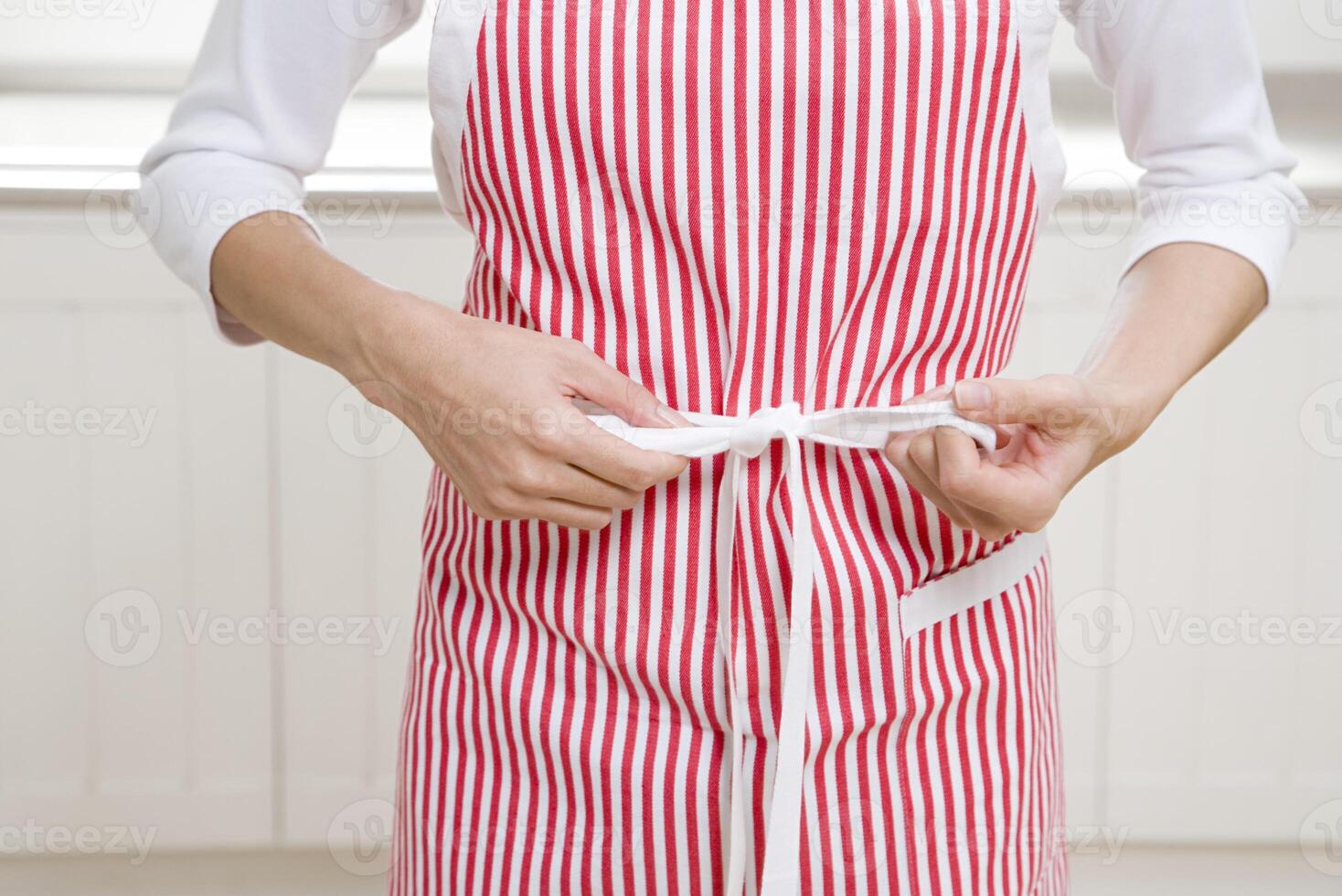 Woman tying apron strings photo