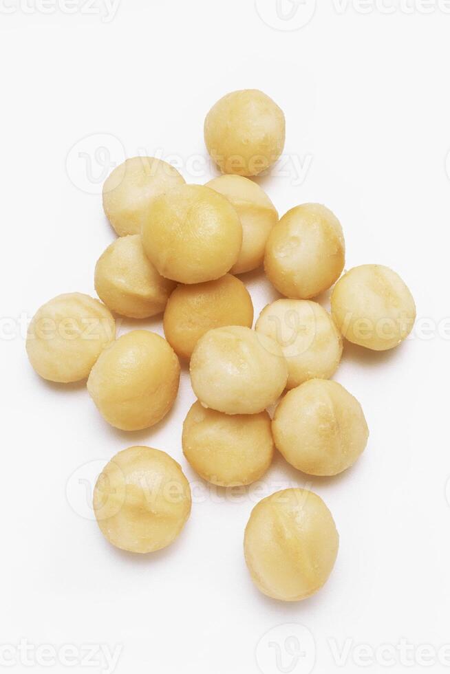 Raw Macadamia Nuts on Wooden Background photo