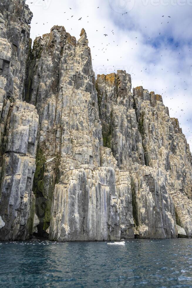 rocks waterfall and glacier at the Alkefjellet between Spitsbergen and Nordaustlandet on Svalbard, Norway photo