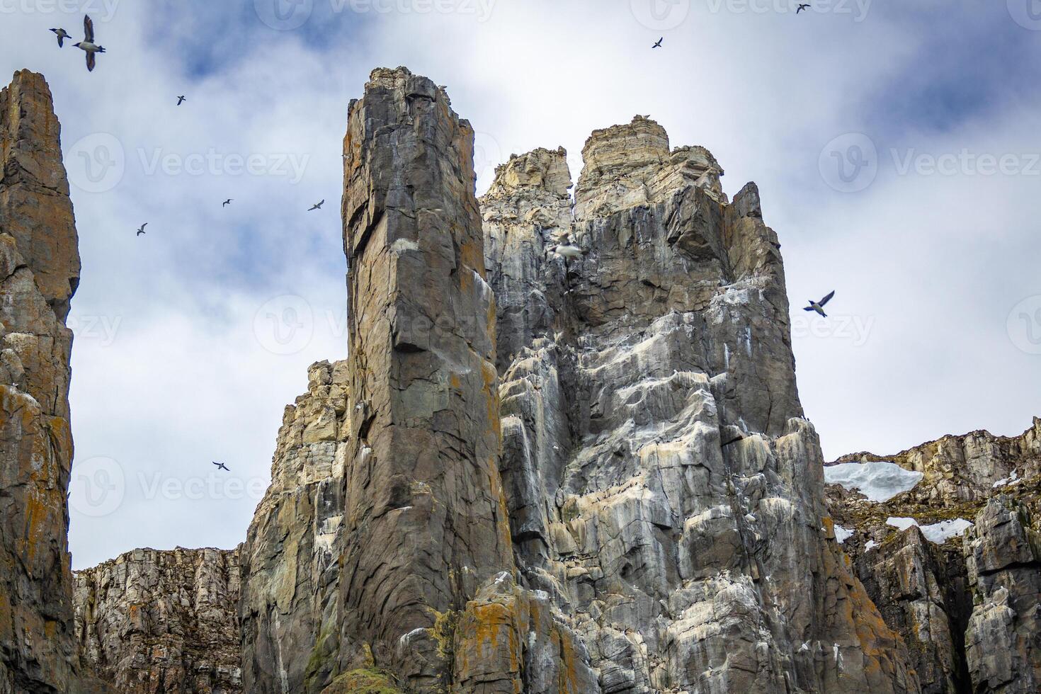 rocks waterfall and glacier at the Alkefjellet between Spitsbergen and Nordaustlandet on Svalbard, Norway photo