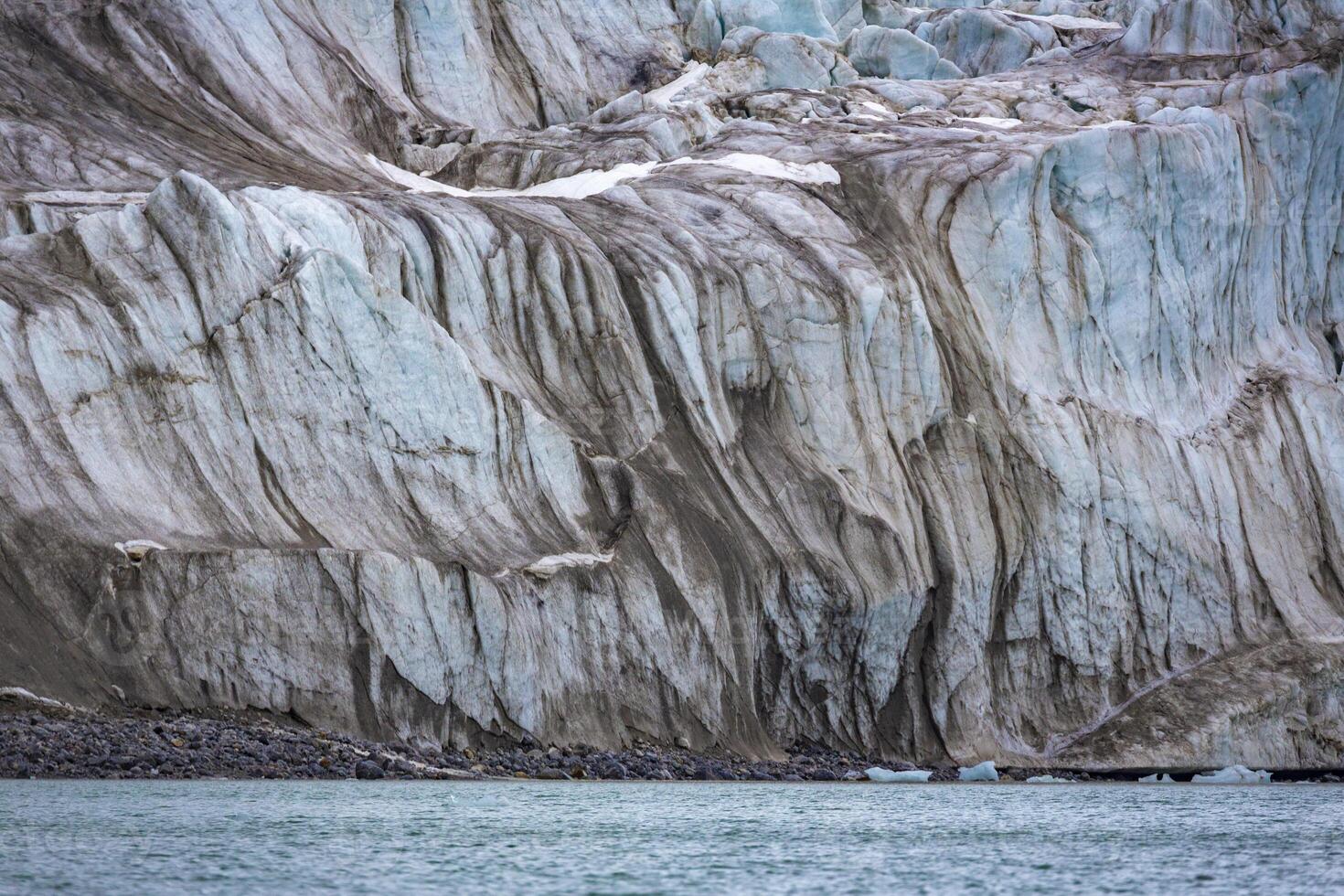 cruising in the Arctic in the Magdalensfjord on Svalbard along a glacier photo