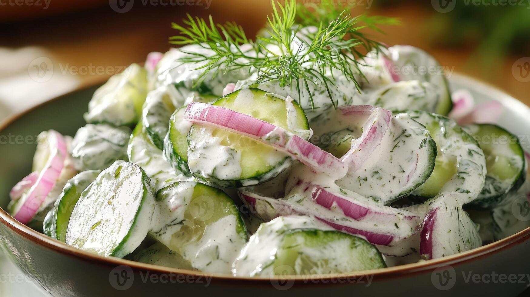 Creamy cucumber salad with red onions and fresh dill garnished photo