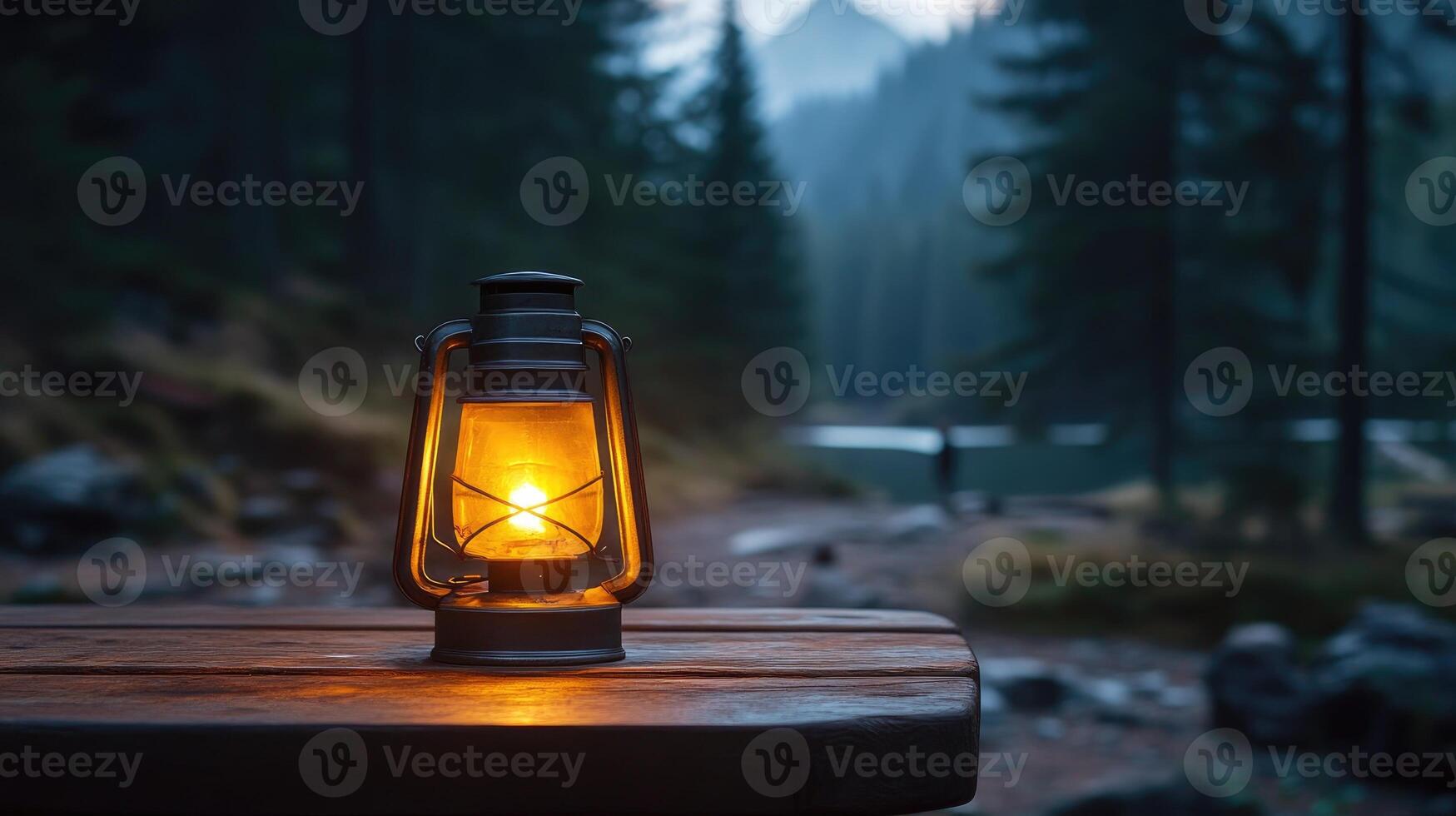 Kerosene lamp glowing on wooden table in misty forest at dusk photo