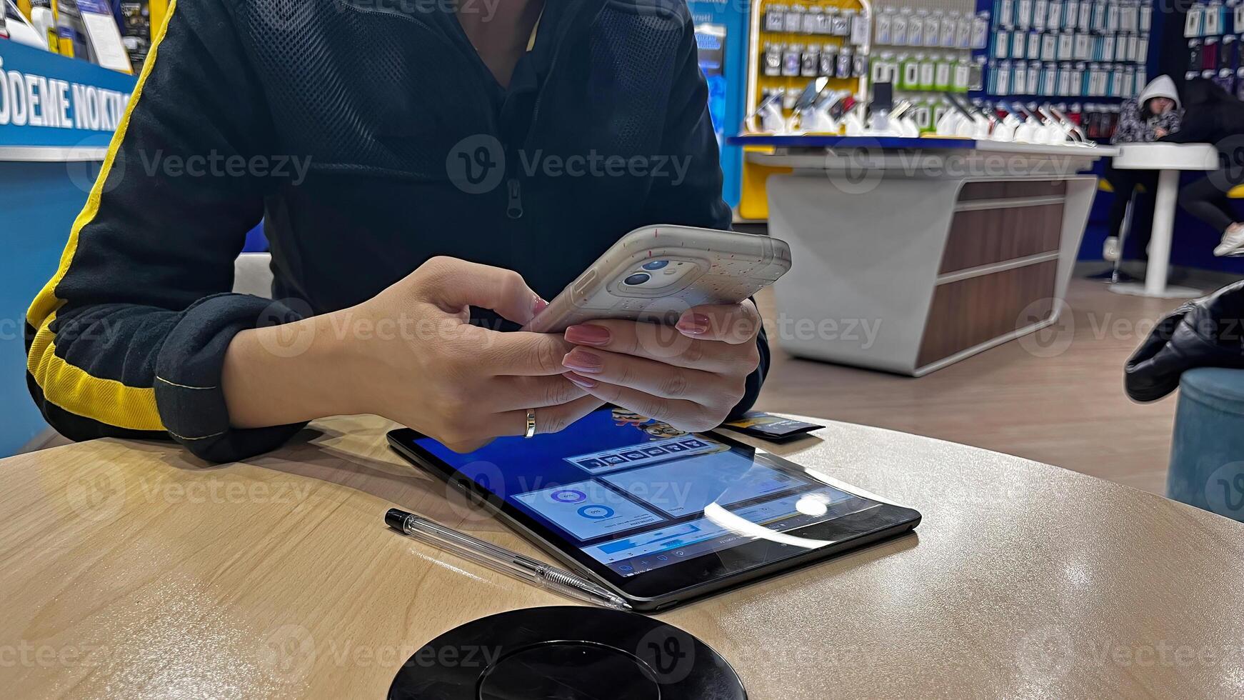 The woman answering her phone in the shop. photo