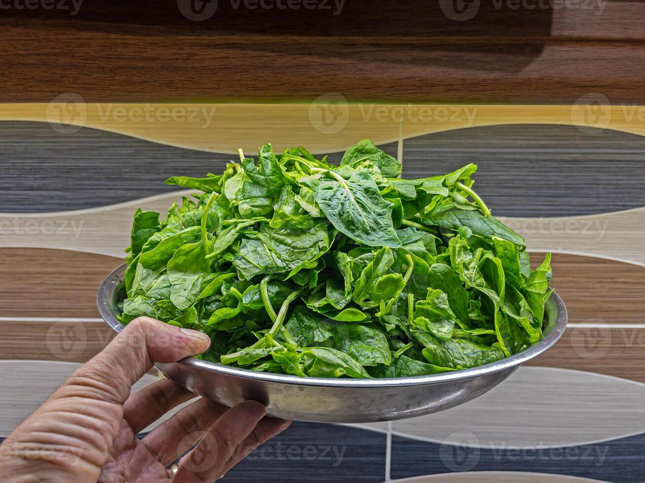Fresh spinach on a plate, cleaned and ready to cook. photo