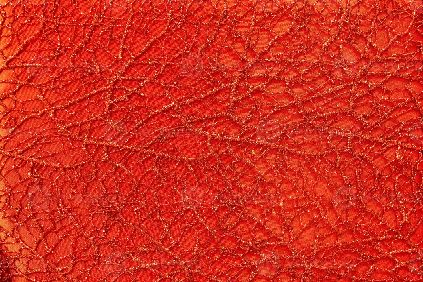 Red shiny lurex and patterned fabric texture. photo