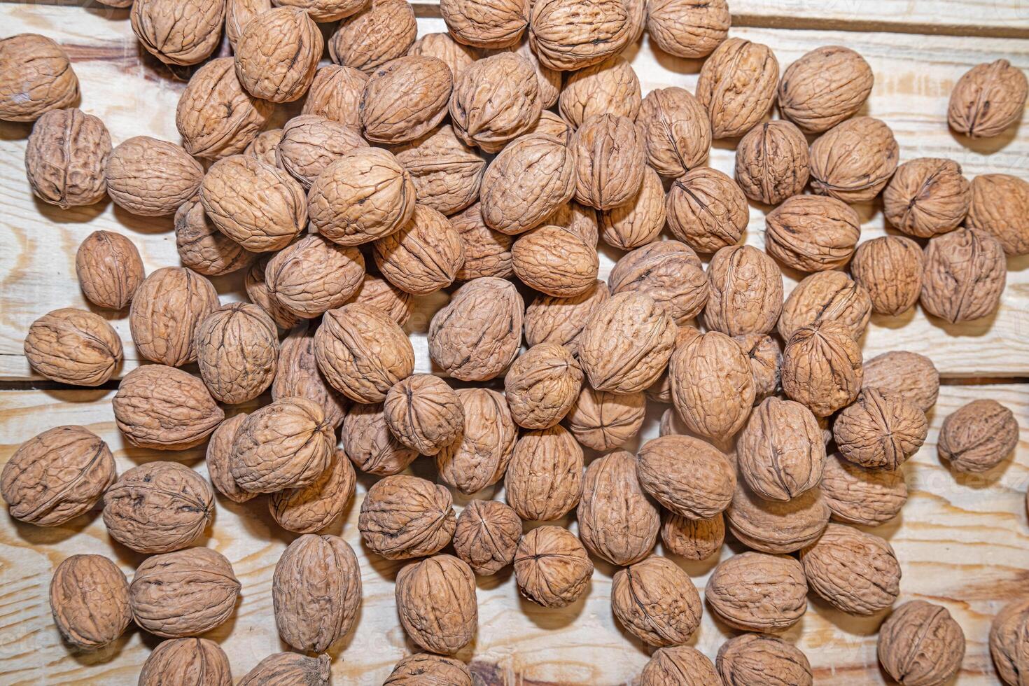 Walnuts on a wooden table. View from above. photo