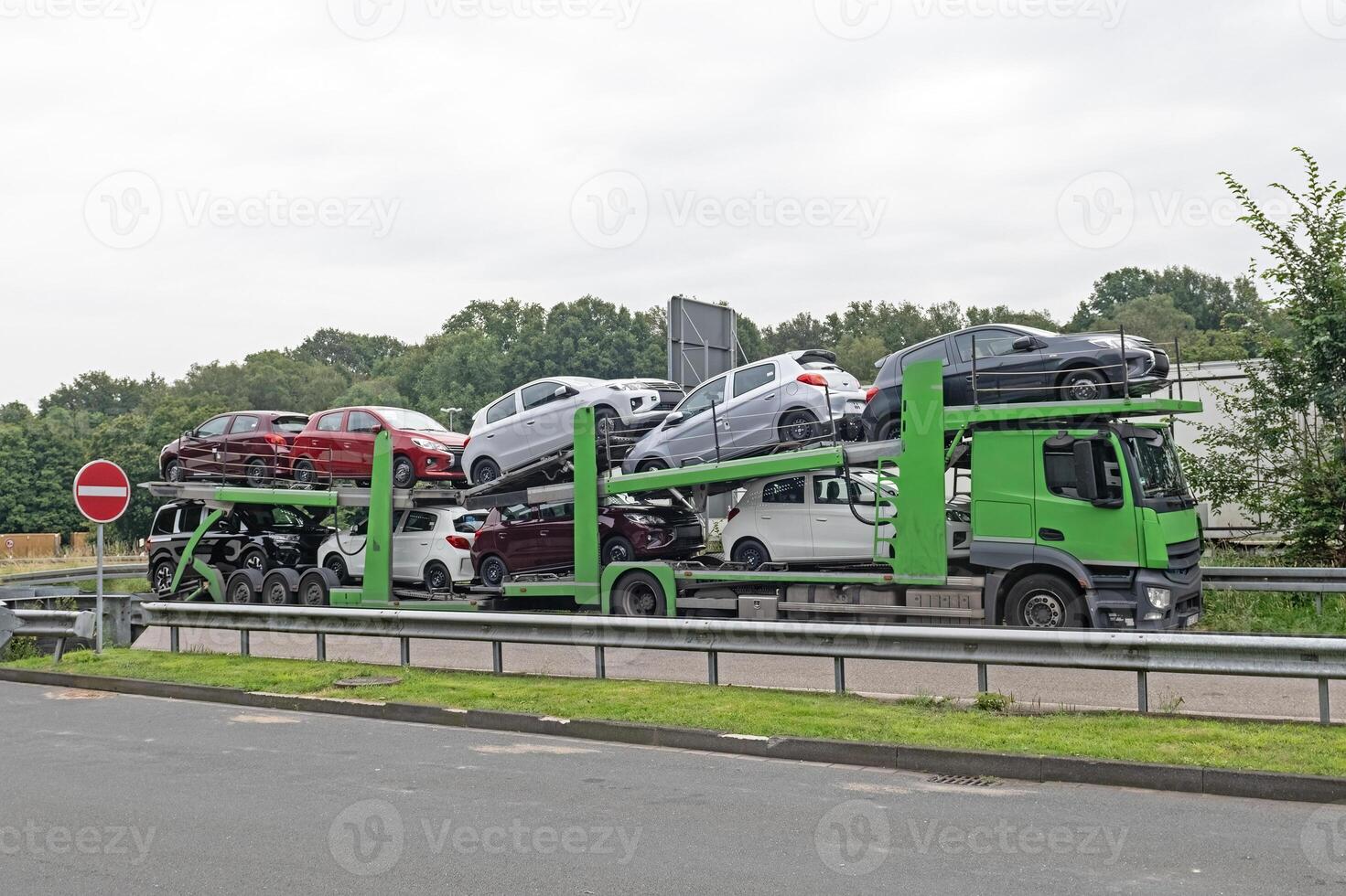Car transporter on the road. Truck transporter Car transportation on a truck on the highway. photo