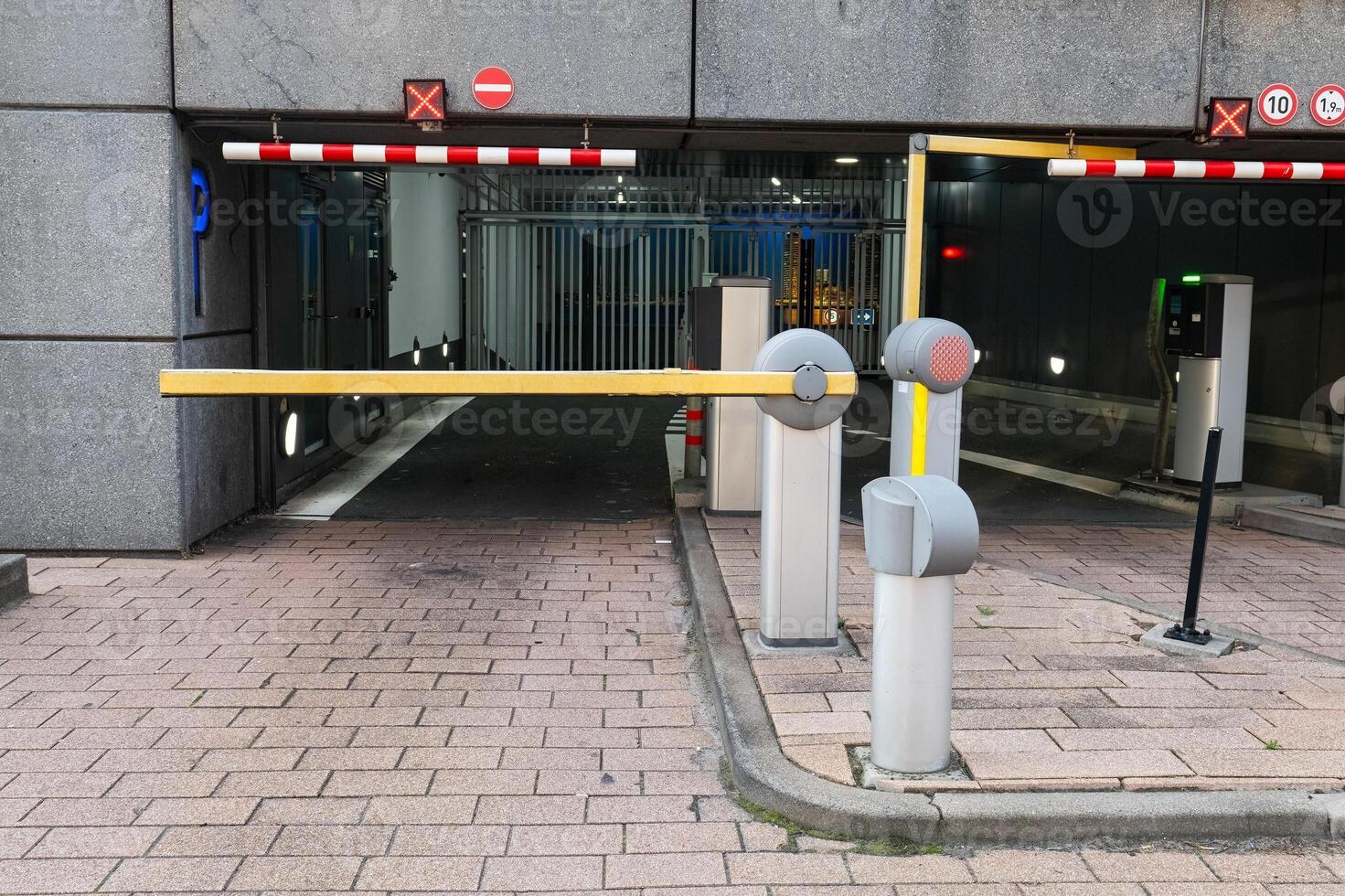 Barrier at the parking lot exit of a building. View of a car barrier gate at the entrance of a building. photo