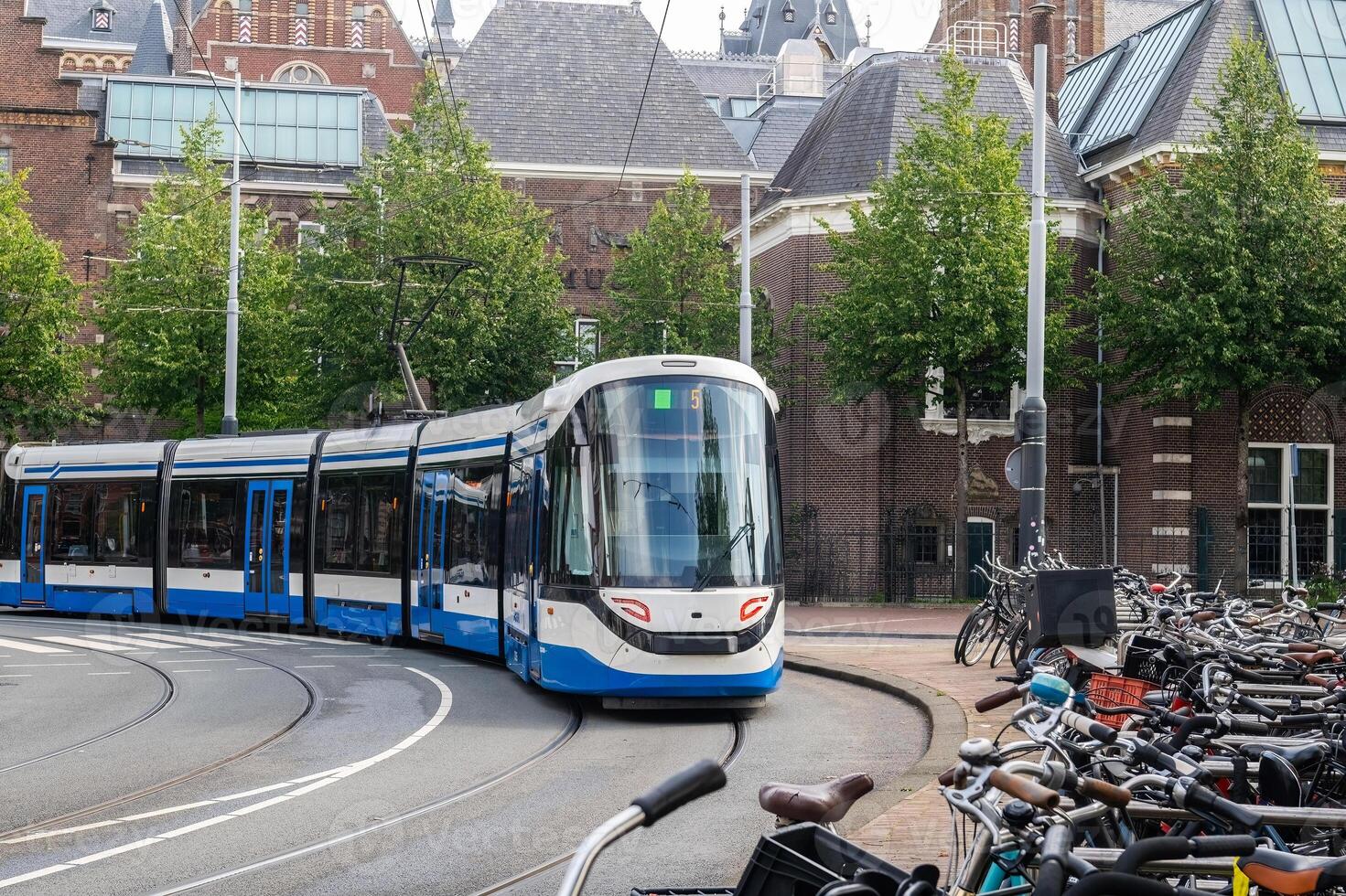 A tram, a public transport vehicle, in motion on rails. photo