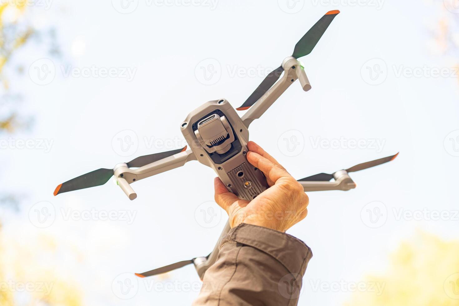 A man holding a drone towards the sky. photo