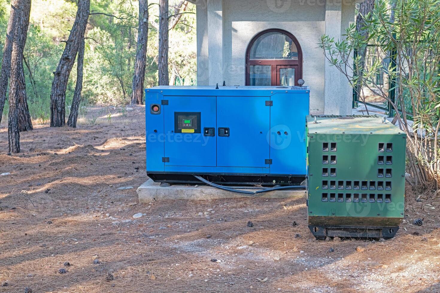 Blue and green coloured generators installed in a plant. Alternative power supply. photo