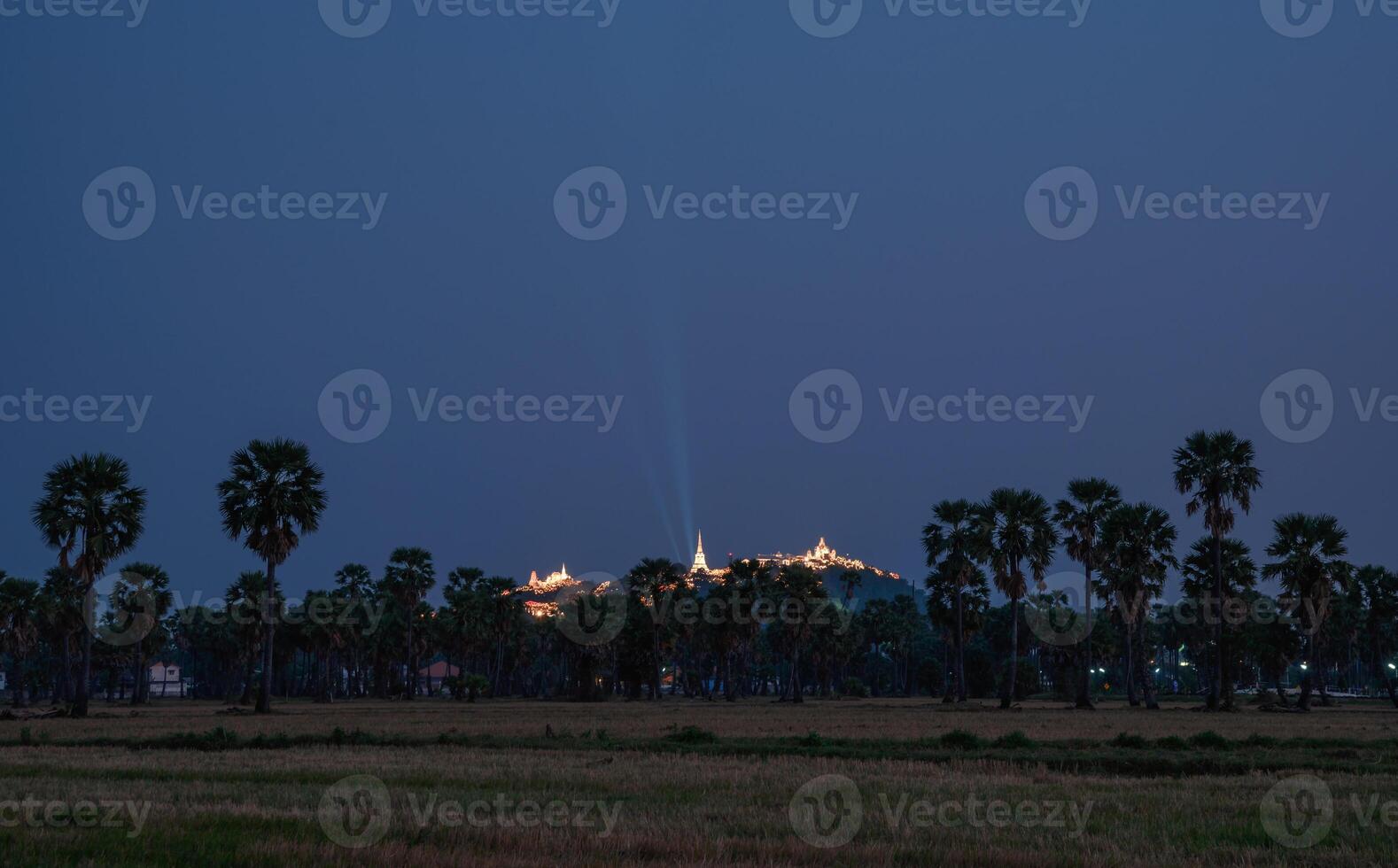Annual festival of Khao Wang temple on hill in sugar plam plantation at dusk photo