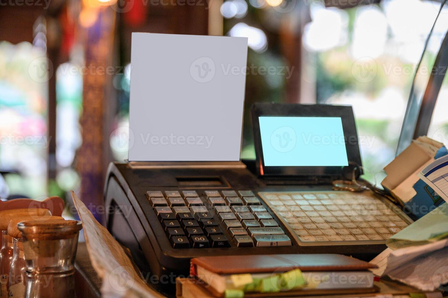 Cashier counter with digital screen and white label on wooden table photo