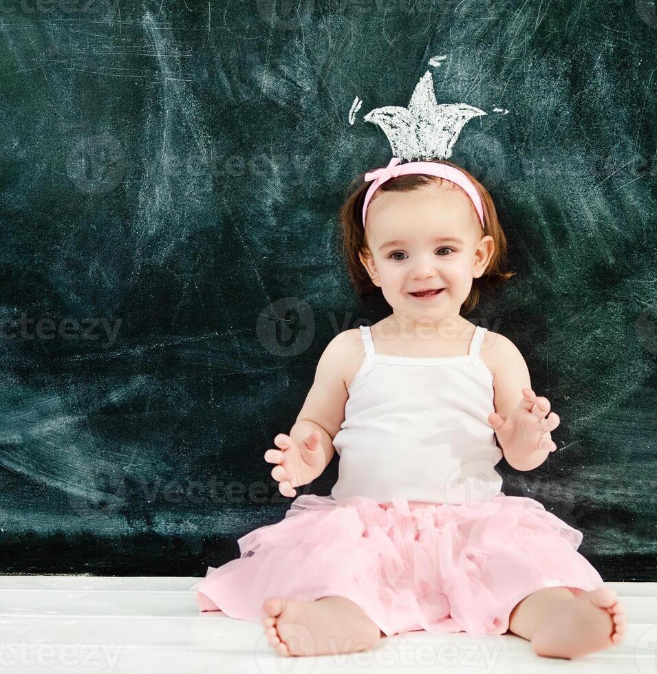 Portrait of the one year old baby wearing ballet suit photo