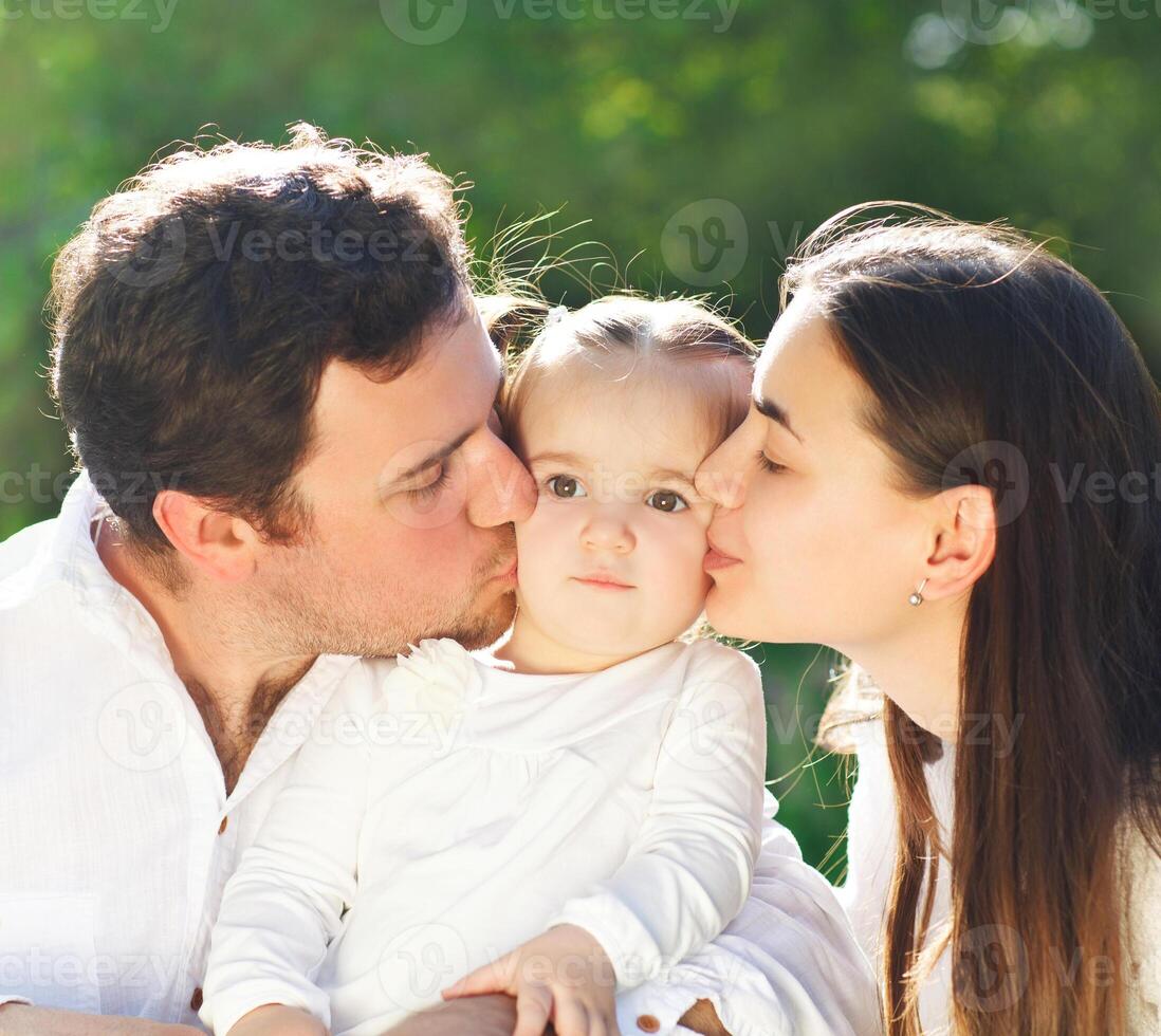 Happy young family with baby girl photo
