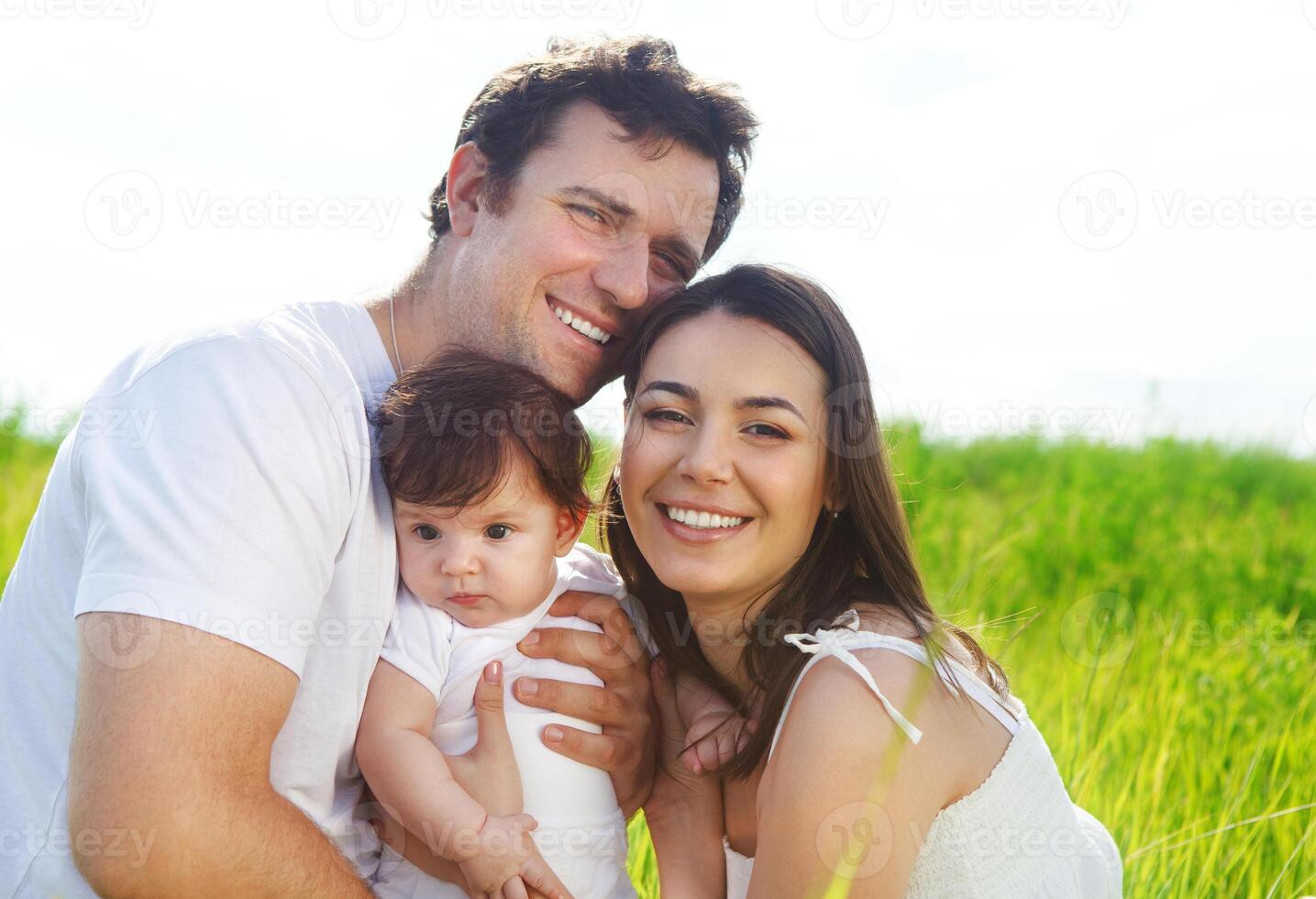 Happy young family with little baby girl photo