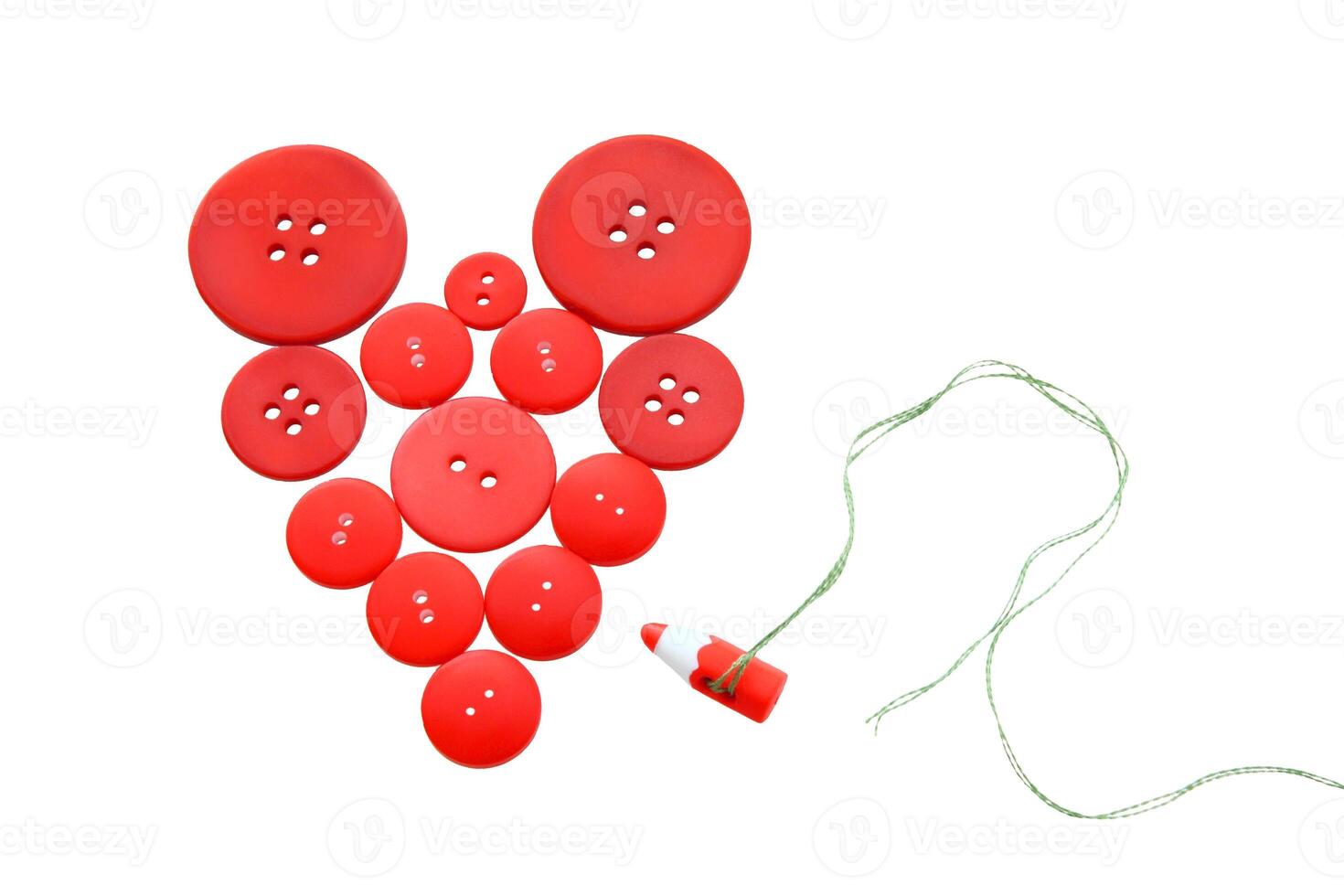a heart shaped button with red buttons on it photo