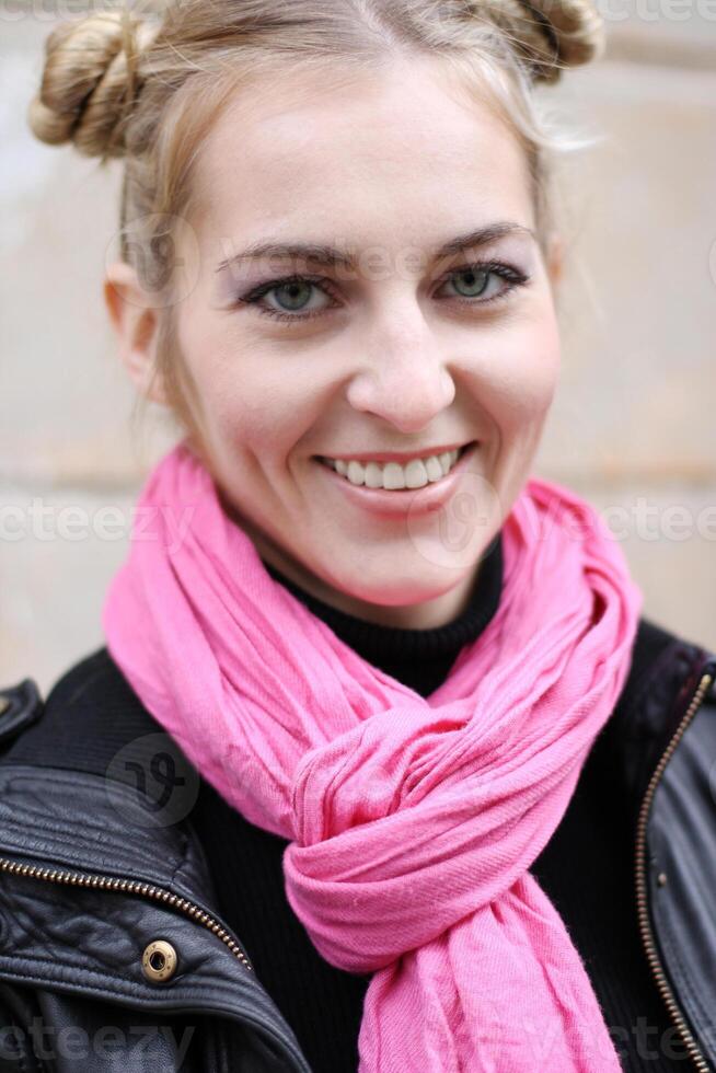 a woman with a pink scarf on her head photo
