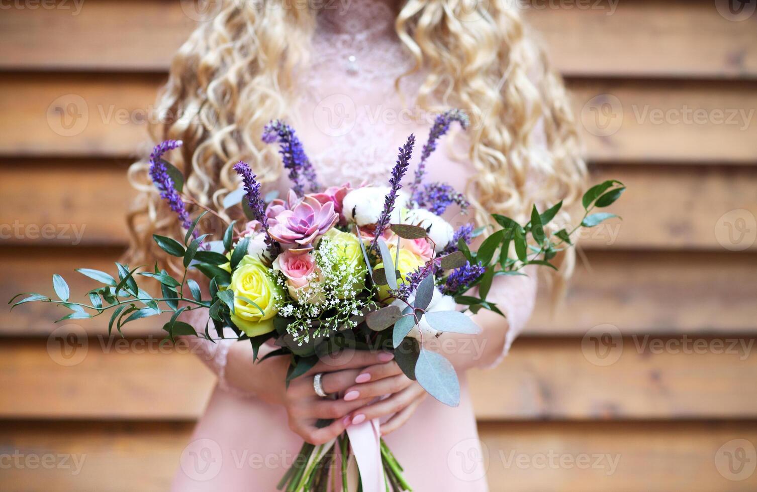 Bride holding the wedding bouquet with succulent flowers photo