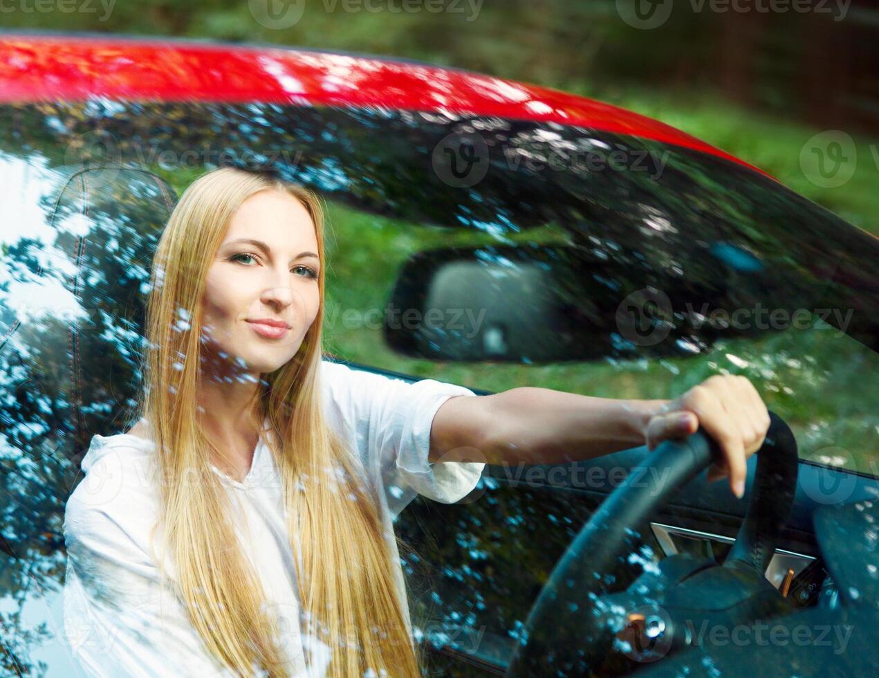 Beautiful blond young woman in a sports car photo