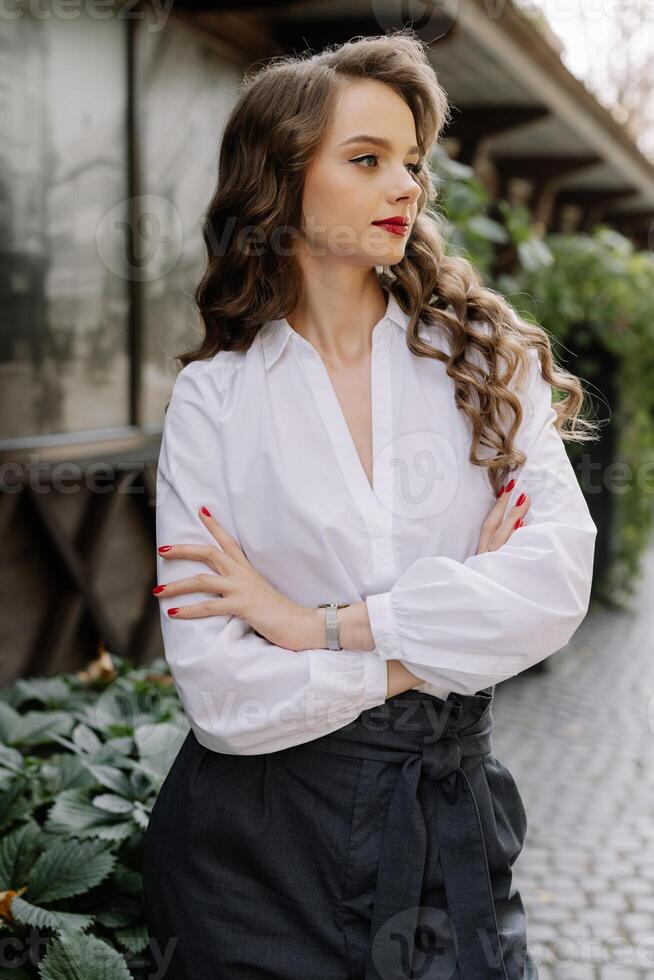 Confident businesswoman posing with folded arms outdoors photo